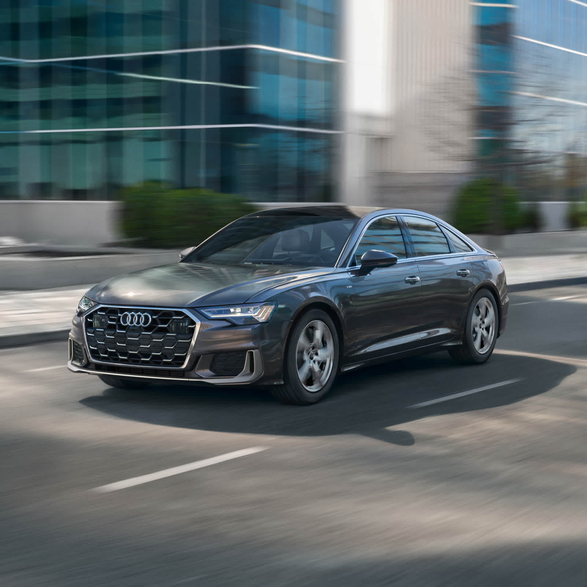 Right side profile view of an Audi A6 accelerating.